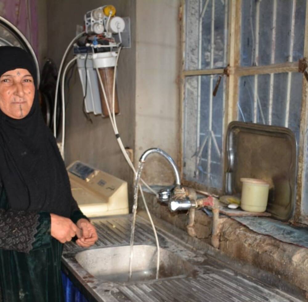 Um Ali, who lost her husband after an ISIL-related attack, receives rehabilitated housing from a UN-Habitat in Iraq, supported by Alwaleed Philanthropies