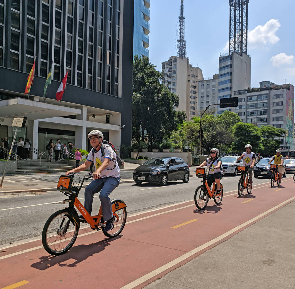 Participants cycling on the bicycle lane on Avenida Paulista (Bike Tour Sao Paulo, 2019)